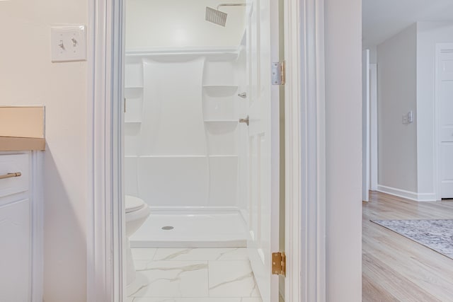 bathroom with walk in shower and hardwood / wood-style flooring