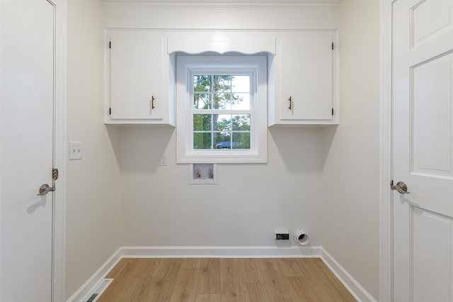 clothes washing area featuring cabinets, light hardwood / wood-style floors, electric dryer hookup, and washer hookup