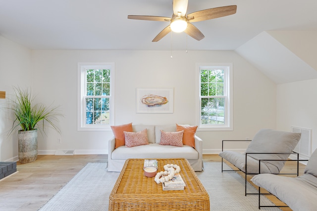 sitting room with ceiling fan, lofted ceiling, a healthy amount of sunlight, and light hardwood / wood-style flooring