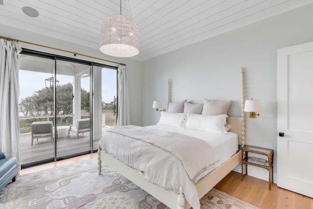 bedroom featuring wood-type flooring, access to outside, and wooden ceiling