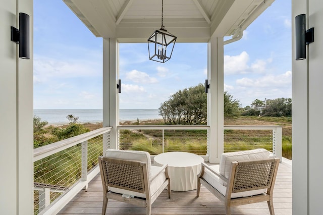 sunroom featuring a wealth of natural light and a water view