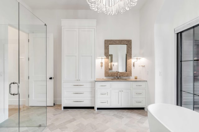 bathroom with a chandelier, vanity, and separate shower and tub