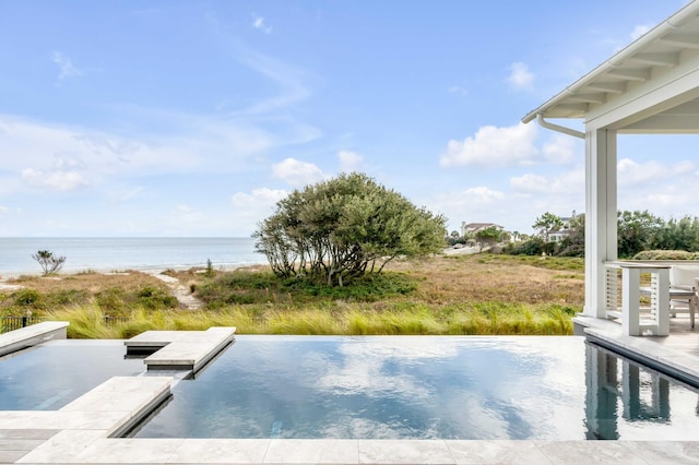 view of swimming pool featuring a water view