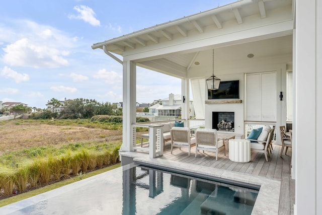 view of patio with an outdoor living space with a fireplace