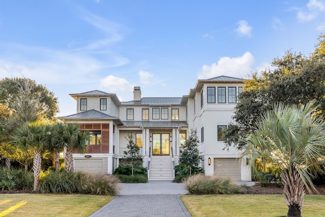 view of front of house featuring a front lawn and a garage