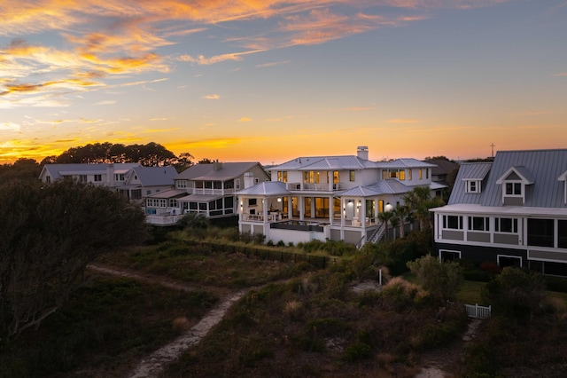 back house at dusk with a balcony