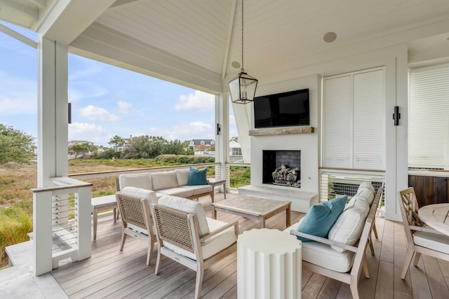 deck featuring an outdoor living space with a fireplace