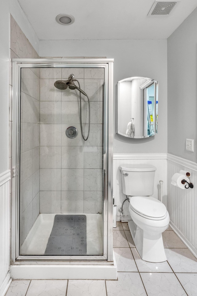 bathroom featuring visible vents, marble finish floor, a stall shower, and toilet