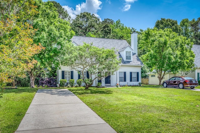 view of front of property with a shingled roof, a chimney, and a front lawn