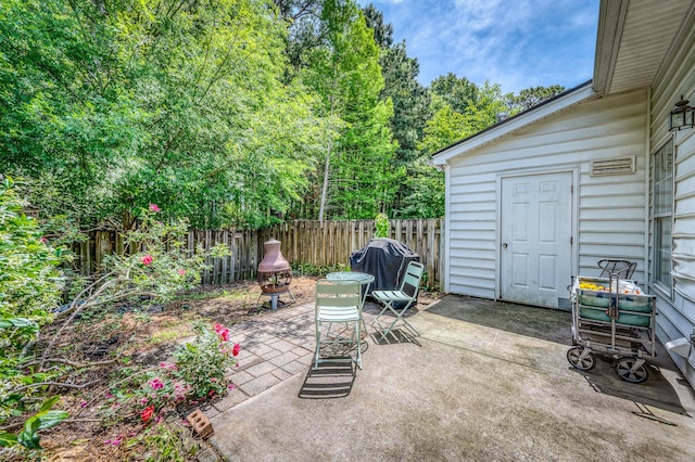 view of patio / terrace featuring fence and a grill