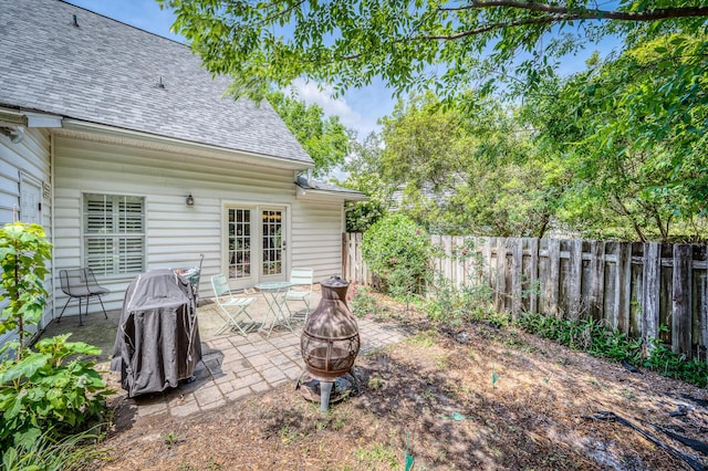 view of yard with a patio, fence, and an outdoor fire pit