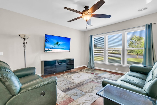 living room with ceiling fan and light wood-type flooring