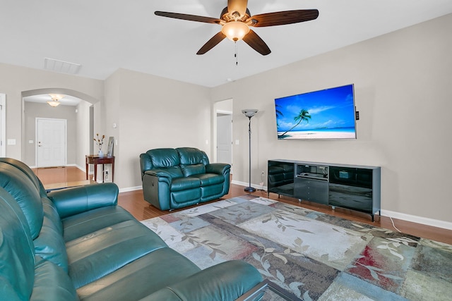 living room with hardwood / wood-style floors and ceiling fan