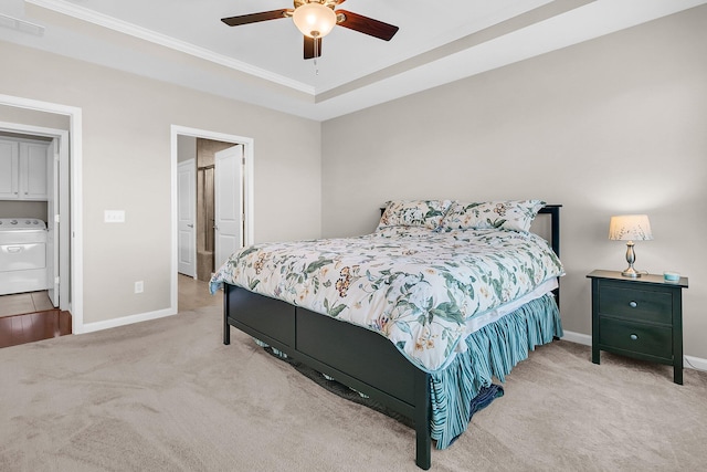 carpeted bedroom featuring ceiling fan, washer / dryer, ensuite bathroom, and crown molding