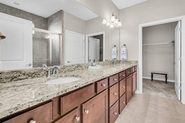 bathroom with tile patterned flooring, vanity, and an enclosed shower