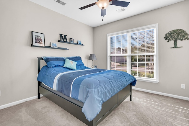 bedroom with ceiling fan and light carpet