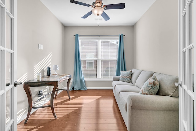 living room with ceiling fan, wood-type flooring, and french doors