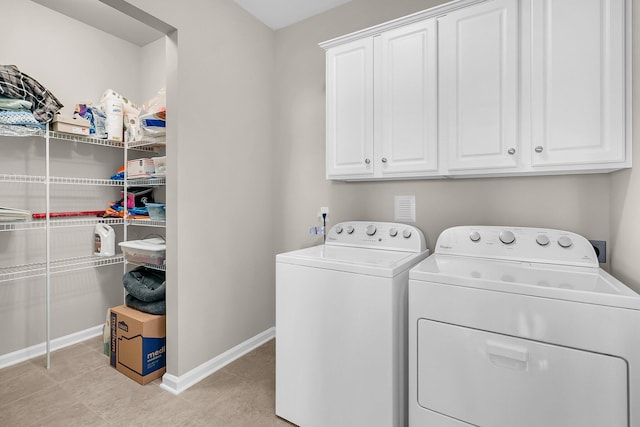 washroom featuring light tile patterned floors, cabinets, and independent washer and dryer