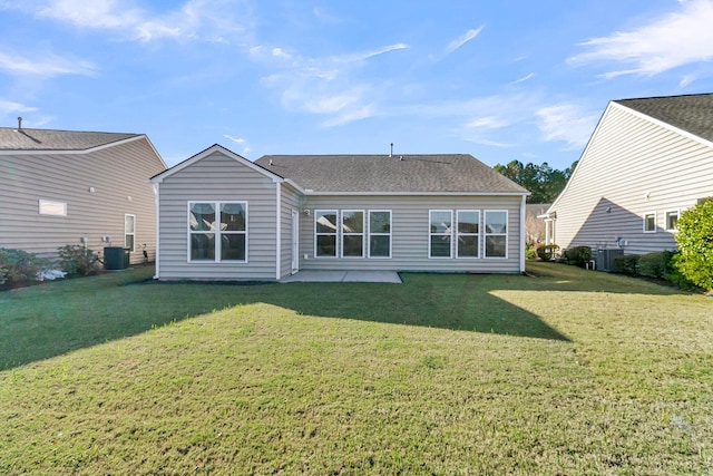 rear view of property featuring a yard and a patio