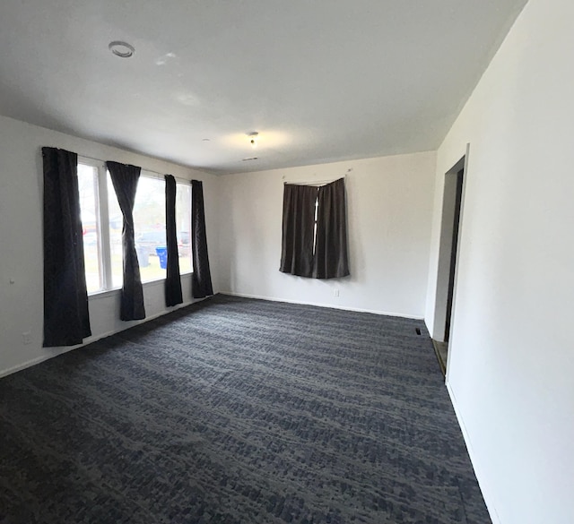 empty room with dark carpet