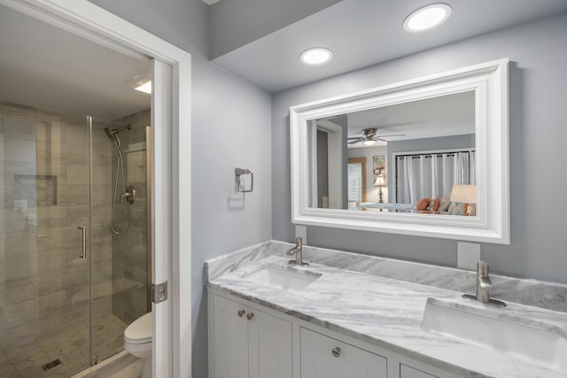 1605 Live Oak Park, Seabrook Island, SC 29455 - full bathroom featuring a stall shower, toilet, double vanity, and a ceiling fan