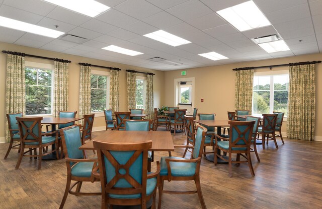 1605 Live Oak Park, Seabrook Island, SC 29455 - dining space featuring wood finished floors, healthy amount of natural light, baseboards, and a drop ceiling