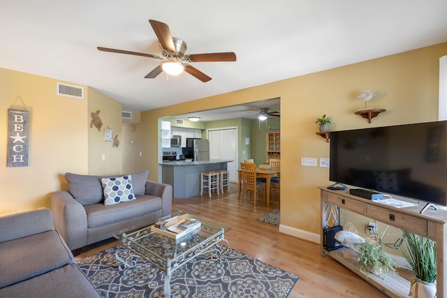 1605 Live Oak Park, Seabrook Island, SC 29455 - living area featuring ceiling fan, light wood-style floors, and baseboards