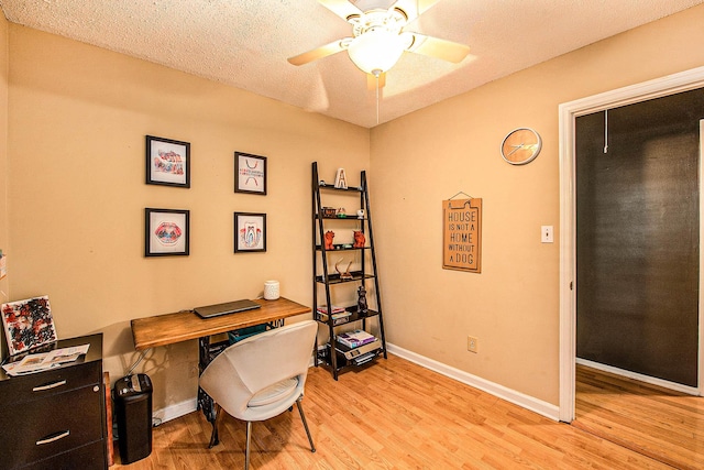 home office featuring ceiling fan, a textured ceiling, and light hardwood / wood-style floors