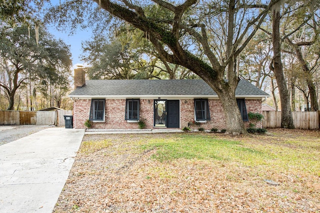 ranch-style home with a shed and a front yard