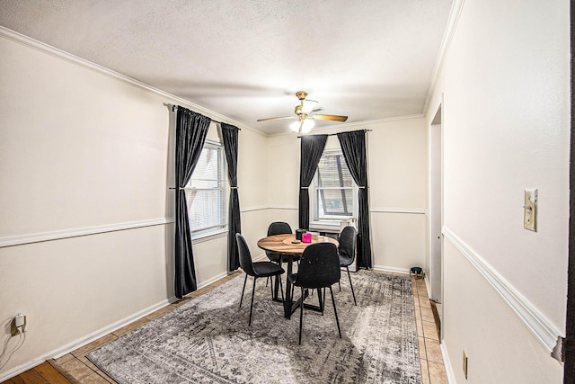 dining room featuring crown molding, tile patterned floors, ceiling fan, and a textured ceiling