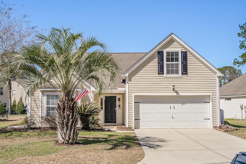 traditional home with concrete driveway and a garage