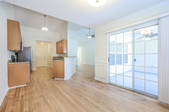 kitchen featuring stainless steel microwave, crown molding, light wood-style flooring, brown cabinetry, and a ceiling fan