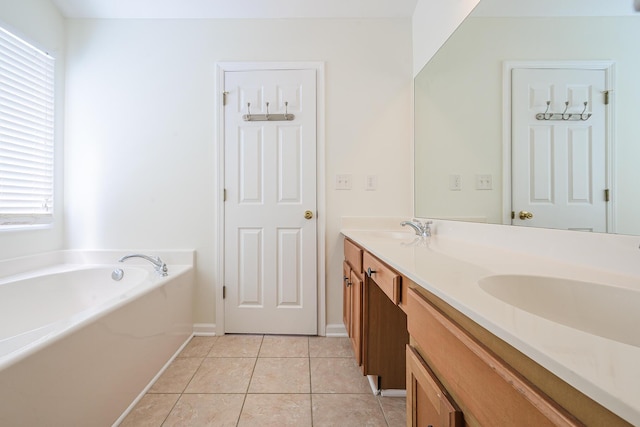 full bathroom with tile patterned floors, double vanity, a garden tub, and a sink