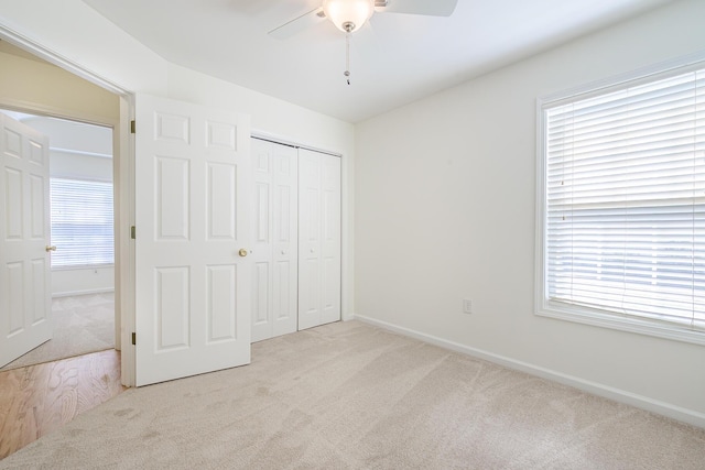 unfurnished bedroom with a closet, baseboards, and carpet floors