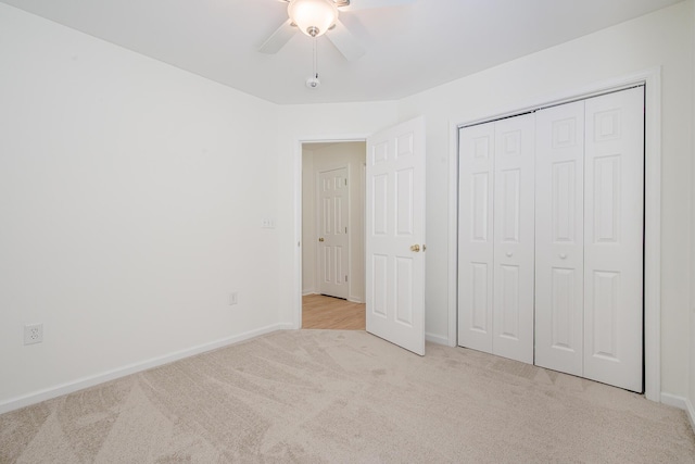 unfurnished bedroom featuring a closet, a ceiling fan, baseboards, and carpet floors