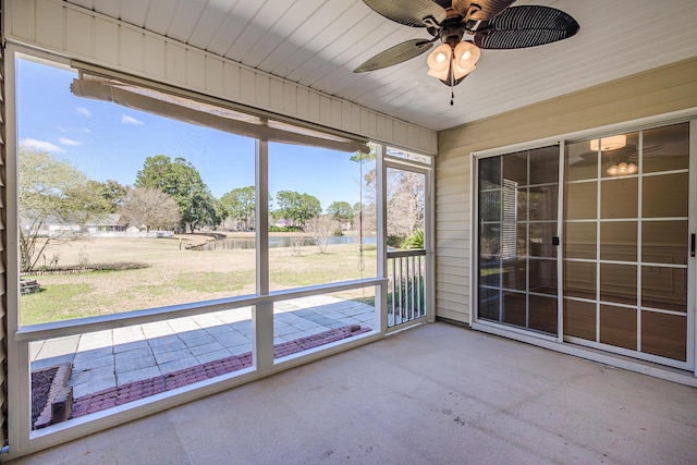 unfurnished sunroom with a ceiling fan