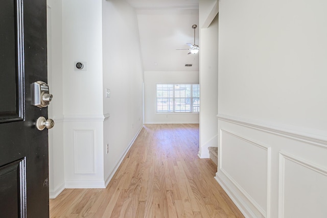 hall featuring stairway, baseboards, and light wood-style floors