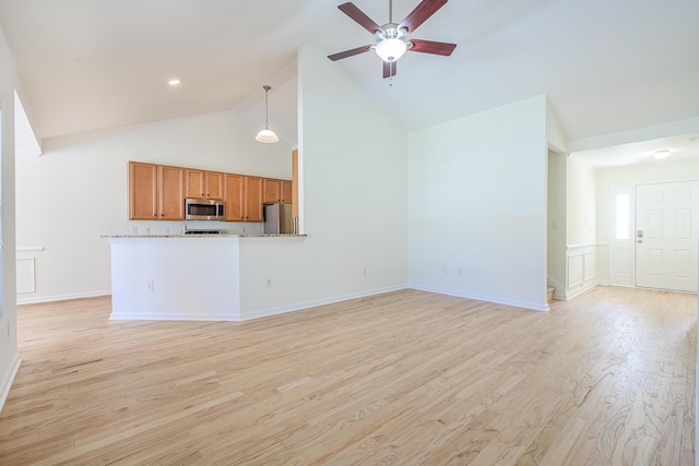 unfurnished living room with baseboards, light wood-style flooring, high vaulted ceiling, and a ceiling fan