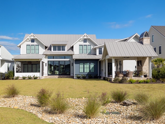 back of property with an outdoor hangout area, ceiling fan, and a lawn