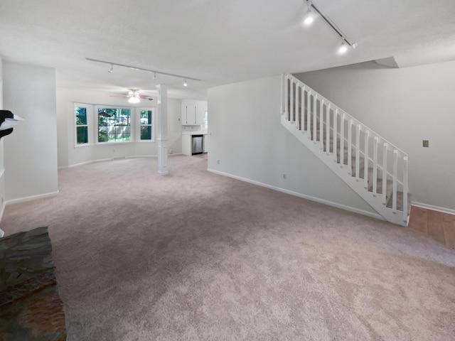 109 Evance Ct, Summerville, SC 29485 - unfurnished living room featuring rail lighting, ceiling fan, carpet, and stairs