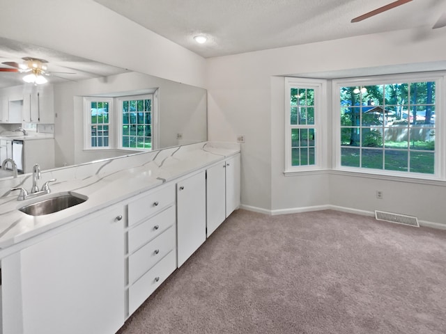 109 Evance Ct, Summerville, SC 29485 - kitchen with a ceiling fan, light carpet, white cabinetry, and a textured ceiling