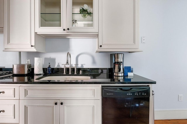 162 Spring St, Charleston, SC 29403 - kitchen featuring dishwasher, a sink, white cabinets, dark countertops, and glass insert cabinets