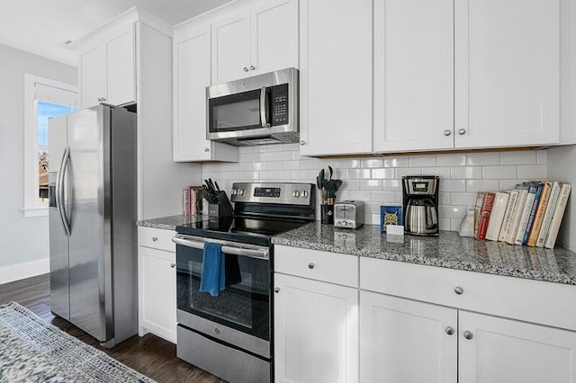 162 Spring St, Charleston, SC 29403 - kitchen with stainless steel appliances, dark wood-style floors, decorative backsplash, and stone counters