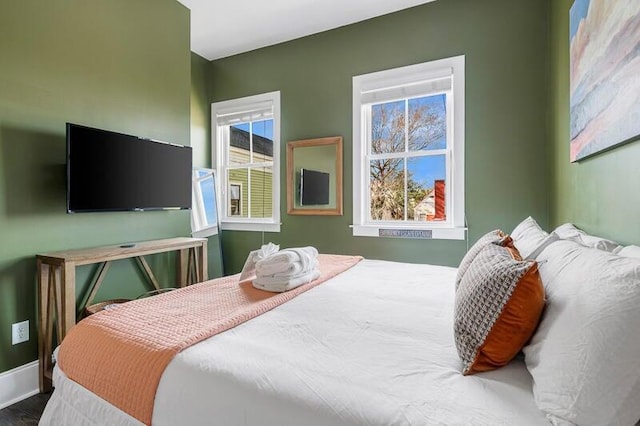 162 Spring St, Charleston, SC 29403 - bedroom with multiple windows, baseboards, and wood finished floors