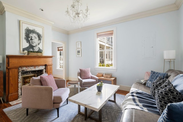 162 Spring St, Charleston, SC 29403 - living room featuring wood finished floors, ornamental molding, a chandelier, baseboards, and a stone fireplace