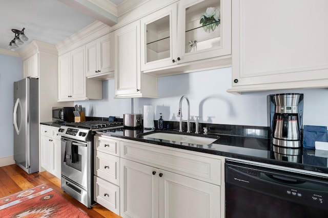 162 Spring St, Charleston, SC 29403 - kitchen featuring black appliances, a sink, light wood-style flooring, white cabinets, and crown molding