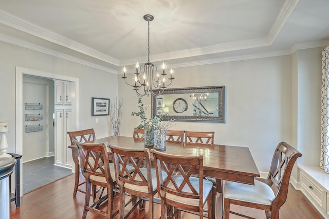 dining space with crown molding, dark hardwood / wood-style flooring, and a chandelier