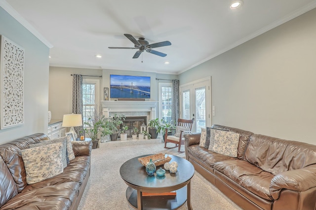 living room with ceiling fan, ornamental molding, and carpet floors