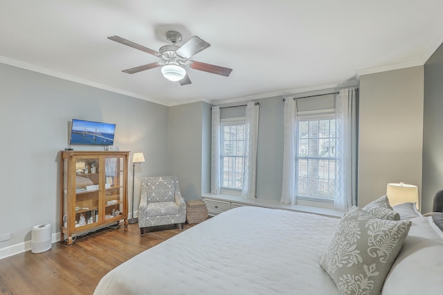 bedroom featuring ceiling fan, ornamental molding, and hardwood / wood-style floors