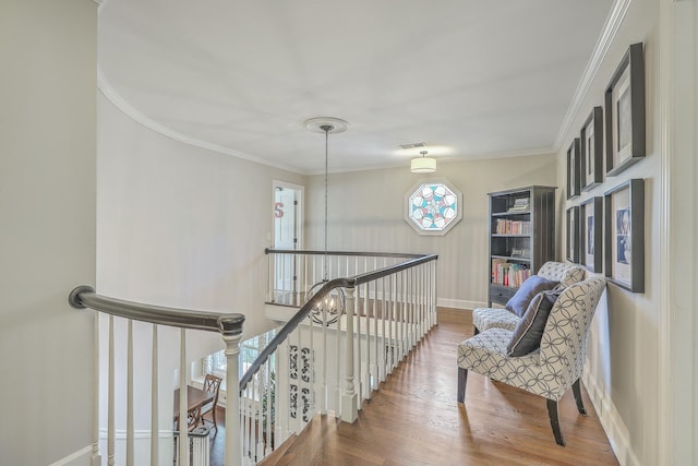 corridor featuring ornamental molding and wood-type flooring